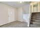 Welcoming entryway with carpeted flooring, front door with glass detail, and staircase access at 11111 Shannon Cir, Hampton, GA 30228