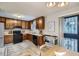 Functional kitchen featuring wooden cabinets, black appliances, and modern tile flooring at 11111 Shannon Cir, Hampton, GA 30228