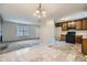 Open-concept kitchen flows into the living area, featuring neutral tile flooring at 11111 Shannon Cir, Hampton, GA 30228