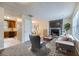 Inviting living room featuring a stone fireplace, plush carpet, and neutral decor at 11111 Shannon Cir, Hampton, GA 30228