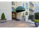 Elegant building entrance with covered awning and well-manicured landscaping creates a welcoming arrival at 3638 Peachtree Rd # 306, Atlanta, GA 30319