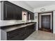 Kitchen featuring black cabinets, granite counters and stainless steel sink at 3638 Peachtree Rd # 306, Atlanta, GA 30319