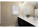 Well-lit bathroom with dual sinks, modern fixtures, and a clean, minimalist design at 1760 Grand Oaks Drive, Woodstock, GA 30188