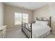 Cozy bedroom with soft lighting, neutral decor, and a view of the outdoors at 1760 Grand Oaks Drive, Woodstock, GA 30188