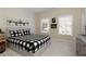 Comfortable bedroom with plaid bedding, ample natural light, and modern decor at 1760 Grand Oaks Drive, Woodstock, GA 30188