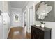 Inviting foyer with hardwood floors, a decorative mirror, and a view of the front door at 1760 Grand Oaks Drive, Woodstock, GA 30188