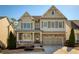 Charming two-story home with stone accents, a welcoming porch, and a well-manicured front yard at 1760 Grand Oaks Drive, Woodstock, GA 30188