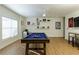 Spacious game room boasting a pool table, ceiling fan, and decorative shelves with sports memorabilia at 1760 Grand Oaks Drive, Woodstock, GA 30188