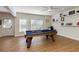 Entertaining game room complete with pool table, ceiling fan, and shelving for displaying decor at 1760 Grand Oaks Drive, Woodstock, GA 30188