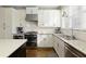 Bright kitchen with stainless steel appliances, granite countertops, and a stylish backsplash at 1760 Grand Oaks Drive, Woodstock, GA 30188