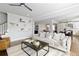 Open-concept living area with hardwood floors, modern decor, and a view into the kitchen at 1760 Grand Oaks Drive, Woodstock, GA 30188