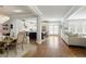 Open concept living area with hardwood floors connecting dining, kitchen, and living spaces at 1760 Grand Oaks Drive, Woodstock, GA 30188
