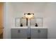 Modern bathroom with dual sinks, gray cabinetry and black fixtures at 2157 Tiffany Ln, Lithonia, GA 30058