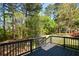 A spacious deck with dark stain overlooks the beautiful trees in the backyard at 2157 Tiffany Ln, Lithonia, GA 30058