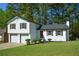 Charming home with a well-maintained lawn, a bright red door, and a two-car garage at 2157 Tiffany Ln, Lithonia, GA 30058