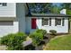 Close-up of a freshly painted home featuring a bright red front door and black shutters at 2157 Tiffany Ln, Lithonia, GA 30058
