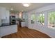 Bright eat-in kitchen features stainless appliances, white cabinets, black countertops and a view to the deck at 2157 Tiffany Ln, Lithonia, GA 30058