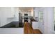Updated kitchen features white cabinetry, granite counters and stainless appliances at 2157 Tiffany Ln, Lithonia, GA 30058
