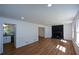 Spacious room featuring a fireplace, wood flooring, and crisp white trim at 2157 Tiffany Ln, Lithonia, GA 30058