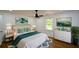 Main bedroom with a ceiling fan, artwork, and a beautiful green accent blanket at 2157 Tiffany Ln, Lithonia, GA 30058