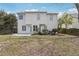 Exterior view of the home from the backyard featuring a grassy lawn and a patio at 2205 Dresden Nw Grn, Kennesaw, GA 30144