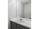 Bathroom vanity features a grey cabinet and an oval sink beneath a large rectangular mirror at 2205 Dresden Nw Grn, Kennesaw, GA 30144