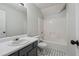 Bright bathroom features a white single sink vanity, a toilet, and a shower-tub combination at 2205 Dresden Nw Grn, Kennesaw, GA 30144