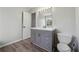 Bathroom with modern vanity, mirror with decorative lighting, and a toilet at 2205 Dresden Nw Grn, Kennesaw, GA 30144