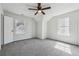 A spacious bedroom featuring a ceiling fan, neutral carpet, and natural light from two windows at 2205 Dresden Nw Grn, Kennesaw, GA 30144