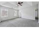 Spacious main bedroom with neutral carpet, a ceiling fan, and natural light from two windows at 2205 Dresden Nw Grn, Kennesaw, GA 30144
