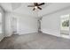 Spacious main bedroom with neutral carpet, a ceiling fan, and multiple closets and entryways at 2205 Dresden Nw Grn, Kennesaw, GA 30144