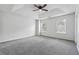 Large main bedroom with neutral carpet, a ceiling fan, and natural light from two windows at 2205 Dresden Nw Grn, Kennesaw, GA 30144