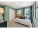 Stylish bedroom with blue accents, a comfortable bed, and natural light from the window at 465 Madison Lakeview Dr, Acworth, GA 30102
