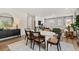 Open-concept dining area with modern decor, including a round table and elegant chairs adjacent to the living room at 465 Madison Lakeview Dr, Acworth, GA 30102