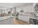 Modern kitchen with white cabinets, stainless steel appliances, and an open view to the living space at 465 Madison Lakeview Dr, Acworth, GA 30102