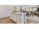 Modern kitchen with a granite island, sleek cabinetry, and an open view into the dining and living areas at 465 Madison Lakeview Dr, Acworth, GA 30102