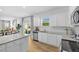 Contemporary kitchen with white cabinetry, stainless steel appliances, and open layout to the living area at 465 Madison Lakeview Dr, Acworth, GA 30102