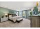 Spacious primary bedroom with an ensuite bath, carpet floors, and ample natural light at 465 Madison Lakeview Dr, Acworth, GA 30102