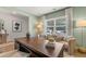 Bright home office with a unique desk, comfortable seating, large window, and calming green walls creating an inspiring work environment at 465 Madison Lakeview Dr, Acworth, GA 30102