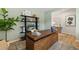 Home office space with decorative desk, stylish shelving, neutral green walls, and natural light creating an ideal workspace at 465 Madison Lakeview Dr, Acworth, GA 30102