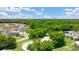 Aerial view of a farm featuring buildings, trees, pasture, and a horse-riding area with a white fence at 8599 Secretariat Dr, Lithonia, GA 30058