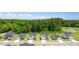 Aerial view of new homes with manicured lawns, alongside mature trees in a developed community at 8599 Secretariat Dr, Lithonia, GA 30058