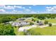 Expansive aerial shot showcasing a horse farm with multiple buildings, pastures, and fenced areas at 8599 Secretariat Dr, Lithonia, GA 30058