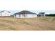 A home's exterior back view shows a large yard and white siding at 8599 Secretariat Dr, Lithonia, GA 30058