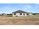 A house with white siding has a big backyard with a grassy lawn at 8599 Secretariat Dr, Lithonia, GA 30058