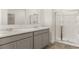 Bathroom featuring dual vanities with marble countertops and a separate shower stall at 8599 Secretariat Dr, Lithonia, GA 30058