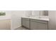Bathroom with dual vanities, marble countertops, and a view of the bedroom at 8599 Secretariat Dr, Lithonia, GA 30058