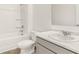 Bathroom features white marble countertops, matching vanity and toilet with a tub and shower combo at 8599 Secretariat Dr, Lithonia, GA 30058