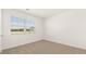 Bright bedroom features neutral carpet, natural light from window and a clean, neutral color palette at 8599 Secretariat Dr, Lithonia, GA 30058