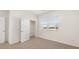 The bedroom features a neutral carpet, a closet and window with natural light at 8599 Secretariat Dr, Lithonia, GA 30058